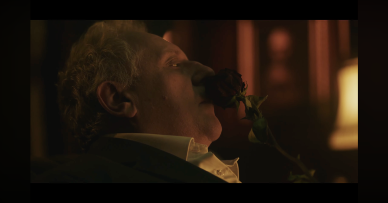 A haunting live-action teaser image for Layers of Fear 3 featuring a mysterious weathered door slightly ajar in a dark hallway.