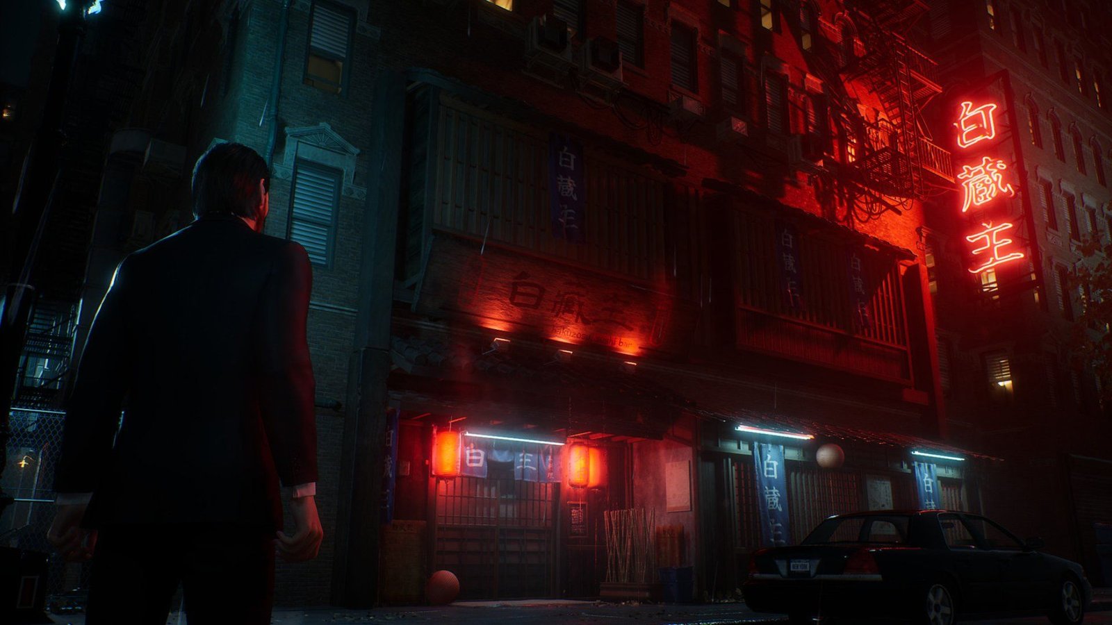 A gamer playing GTA VI on a PS5 Pro in a dimly lit room, showing the vibrant neon lights of Vice City.