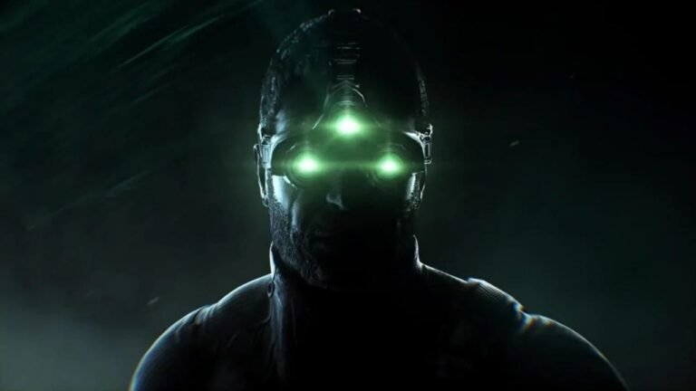 Close up of Sam Fisher’s iconic three-lens green night vision goggles glowing in a dark urban environment, representing the Splinter Cell remake development.