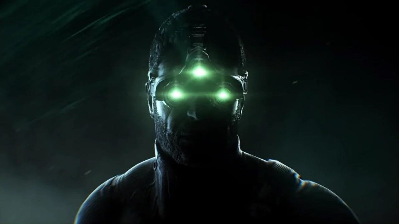 Close up of Sam Fisher’s iconic three-lens green night vision goggles glowing in a dark urban environment, representing the Splinter Cell remake development.