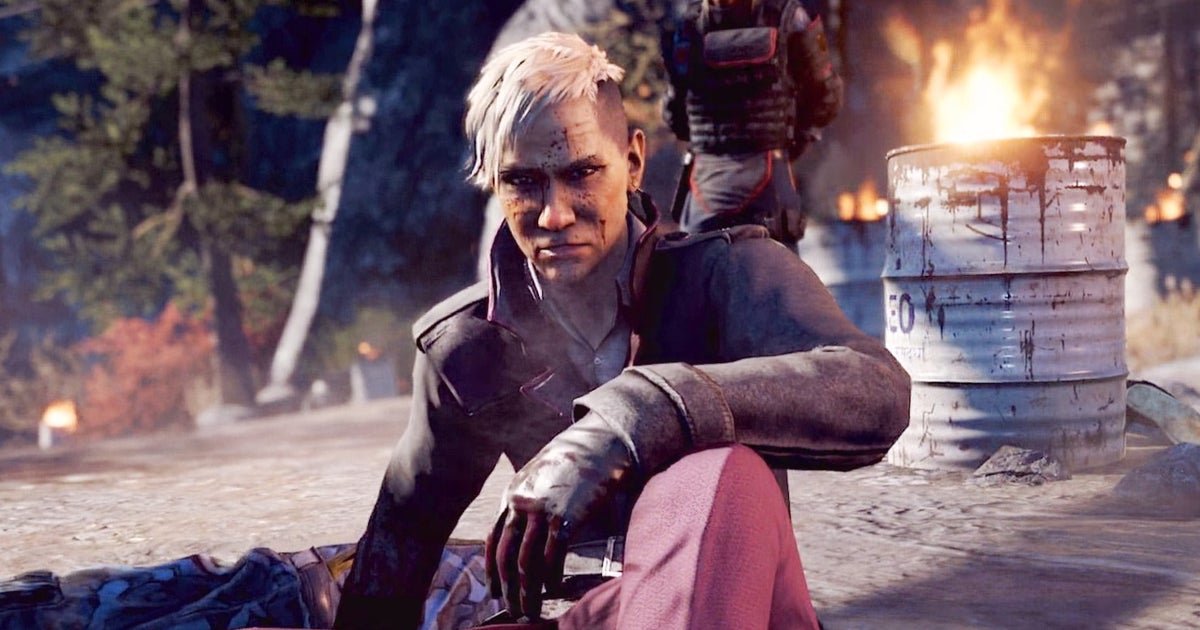 Ubisoft CEO Yves Guillemot delivering a keynote address with blurred Assassin’s Creed and Far Cry logos in the background.